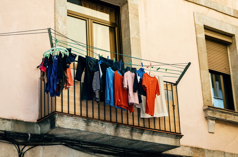 Laundry on the balcony of old house in Barcelona, Catalonia, Spain